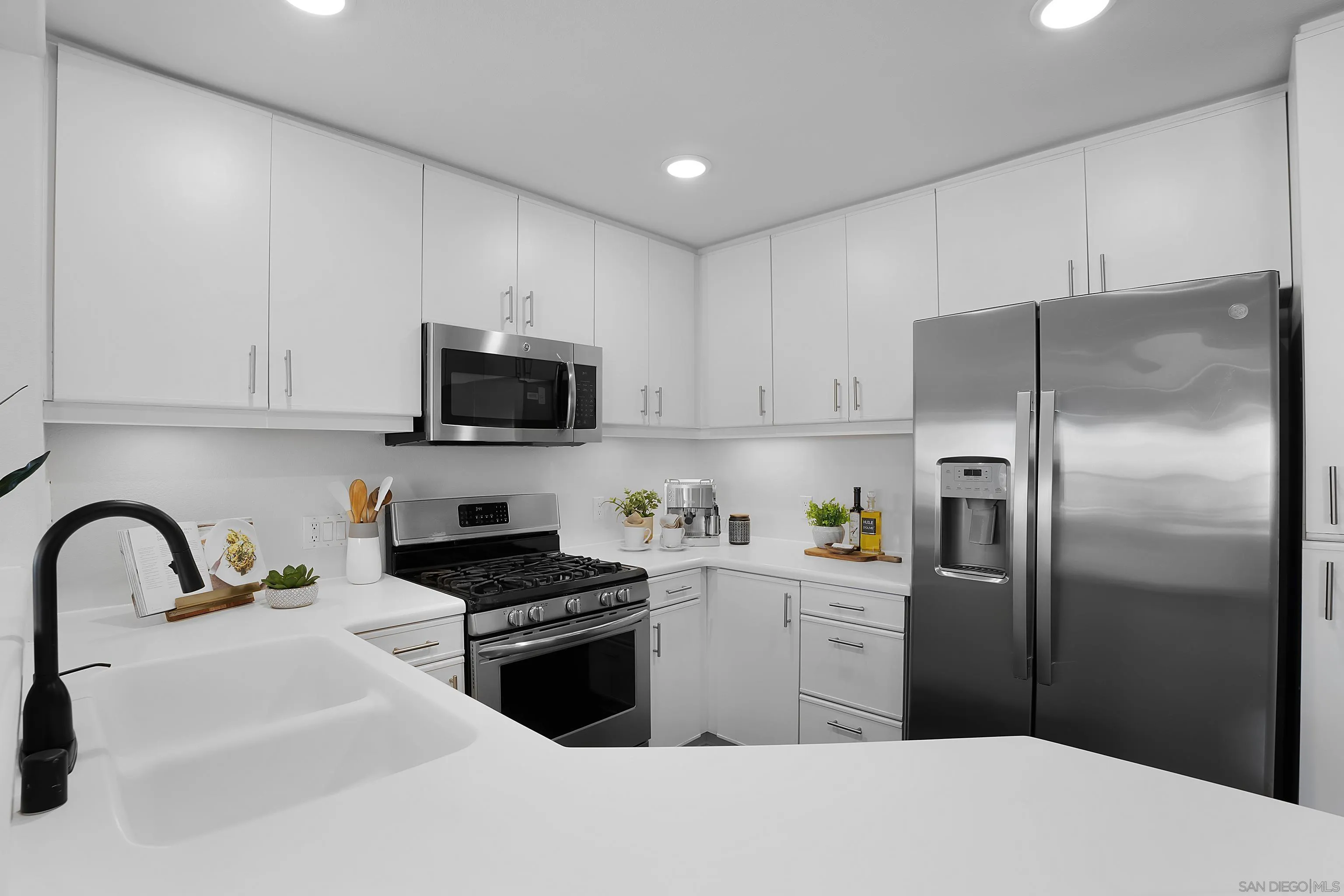 12646 Carmel Country Road, Unit 159 San Diego, CA 92130 - Photo 9 of 35 a kitchen with a refrigerator sink and microwave