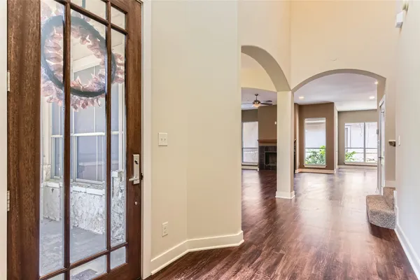 a view of a hallway with wooden floor and glass door