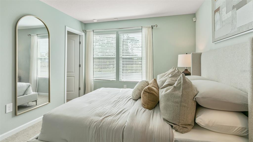292 Palmetto Rdg Road St. Augustine, FL 32095 - Photo 13 of 37 a bedroom with a bed and a mirror