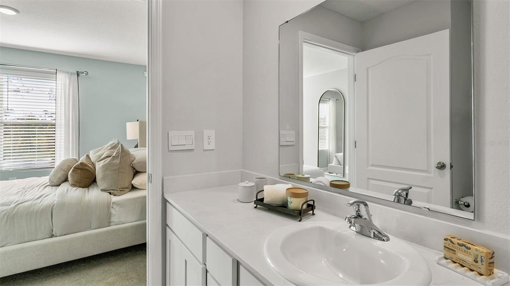292 Palmetto Rdg Road St. Augustine, FL 32095 - Photo 16 of 37 a en suite bathroom with a double vanity sink and a mirror