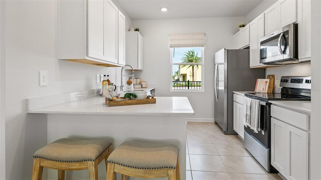 292 Palmetto Rdg Road St. Augustine, FL 32095 - Photo 7 of 37 a kitchen with stainless steel appliances a stove a sink cabinets and a dining table