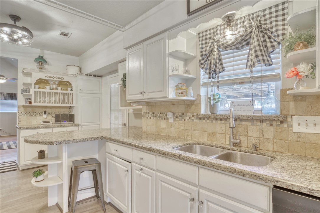 1681 Union Road Madisonville, TX 77864 - Photo 13 of 50 a kitchen with granite countertop a sink a window cabinets and stainless steel appliances