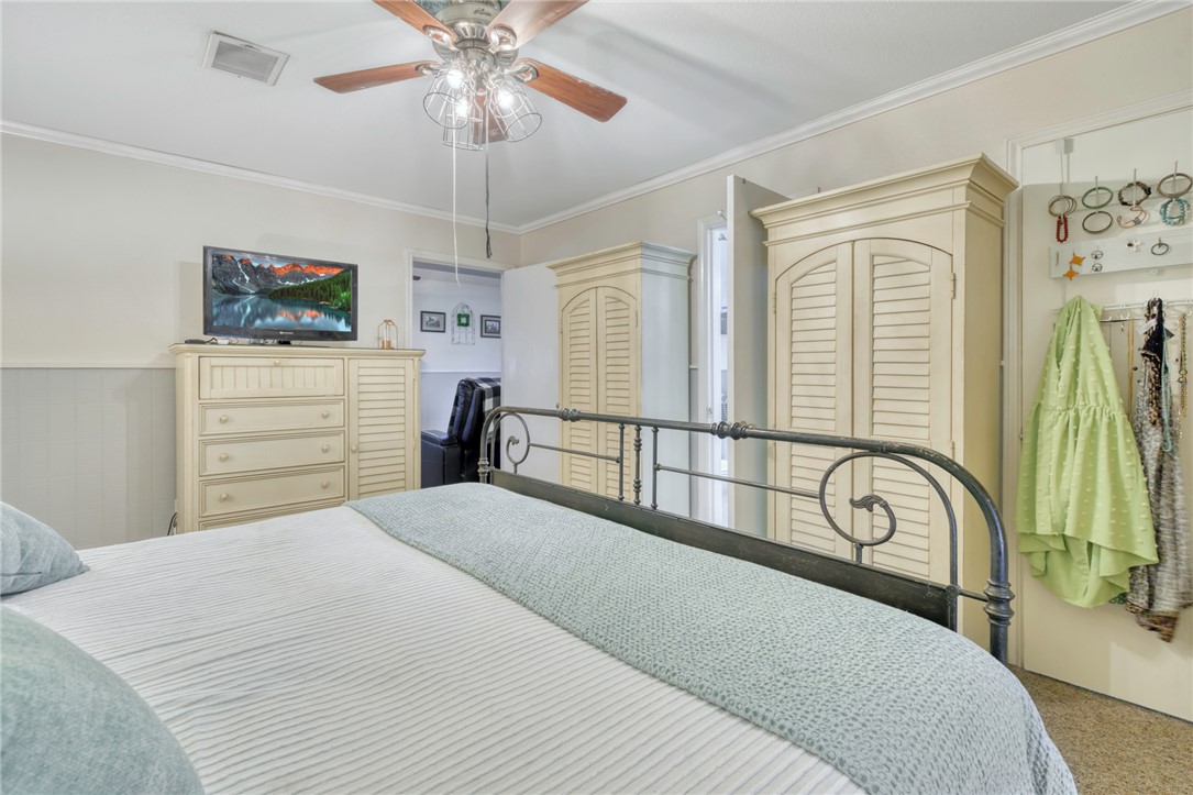 1681 Union Road Madisonville, TX 77864 - Photo 18 of 50 a bedroom with a bed and a chandelier