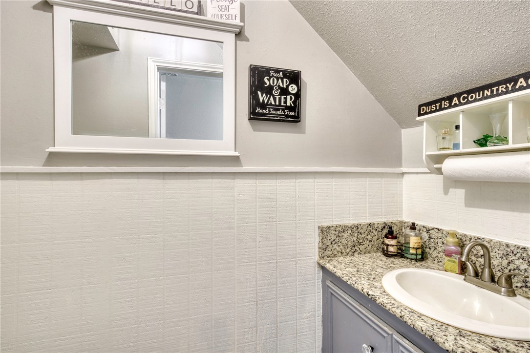 1681 Union Road Madisonville, TX 77864 - Photo 23 of 50 a bathroom with a granite countertop sink and a mirror