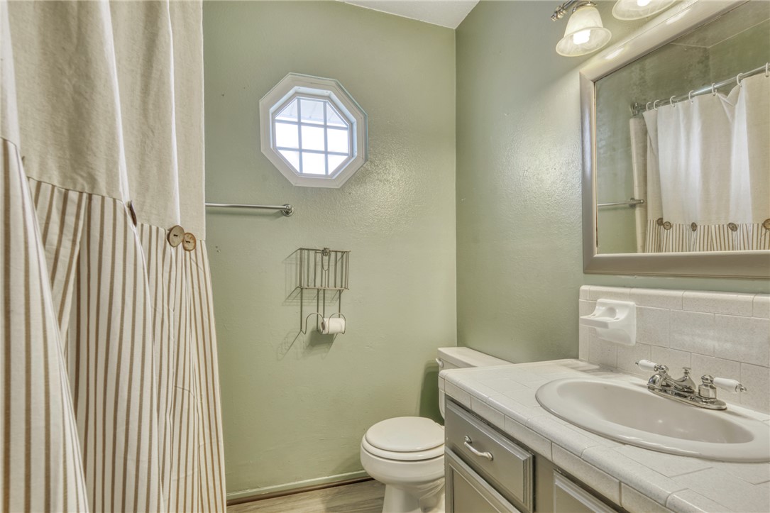 1681 Union Road Madisonville, TX 77864 - Photo 26 of 50 a bathroom with a sink a toilet and a mirror