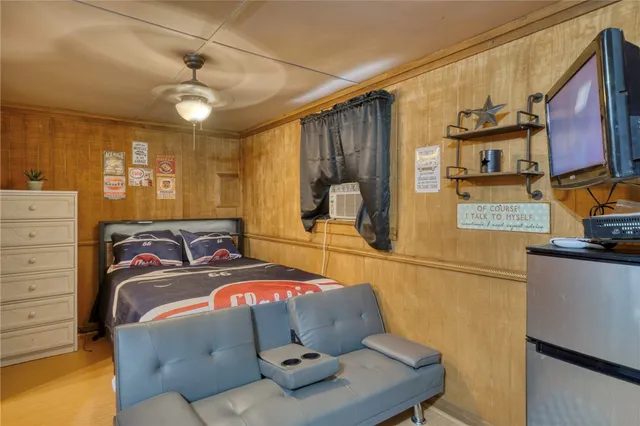 a bedroom with a bed and wooden cabinets