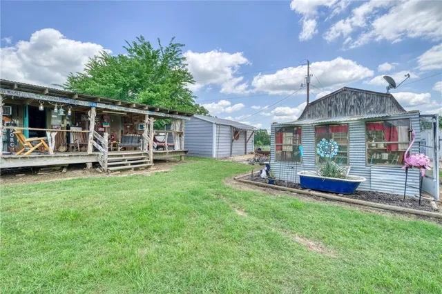 a view of a house with patio and a yard