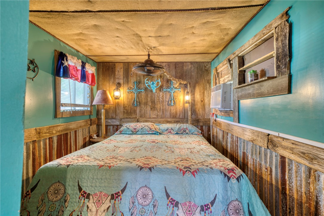 1681 Union Road Madisonville, TX 77864 - Photo 43 of 50 a bedroom with a bed and a large mirror on the dresser