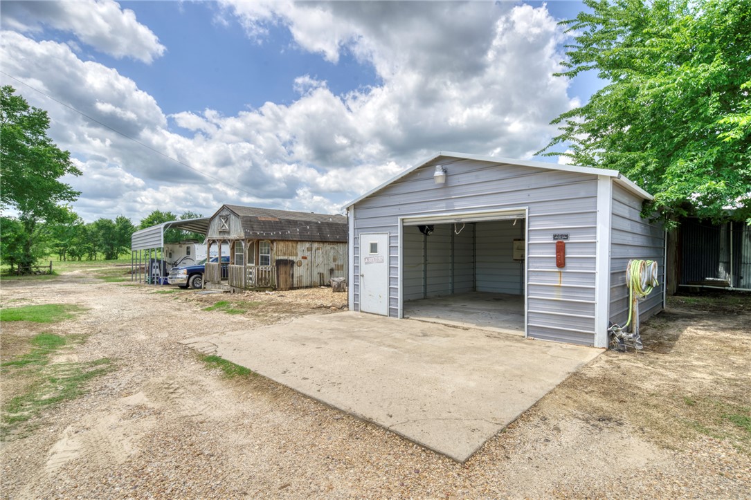 1681 Union Road Madisonville, TX 77864 - Photo 44 of 50 a front view of a house with a yard and garage