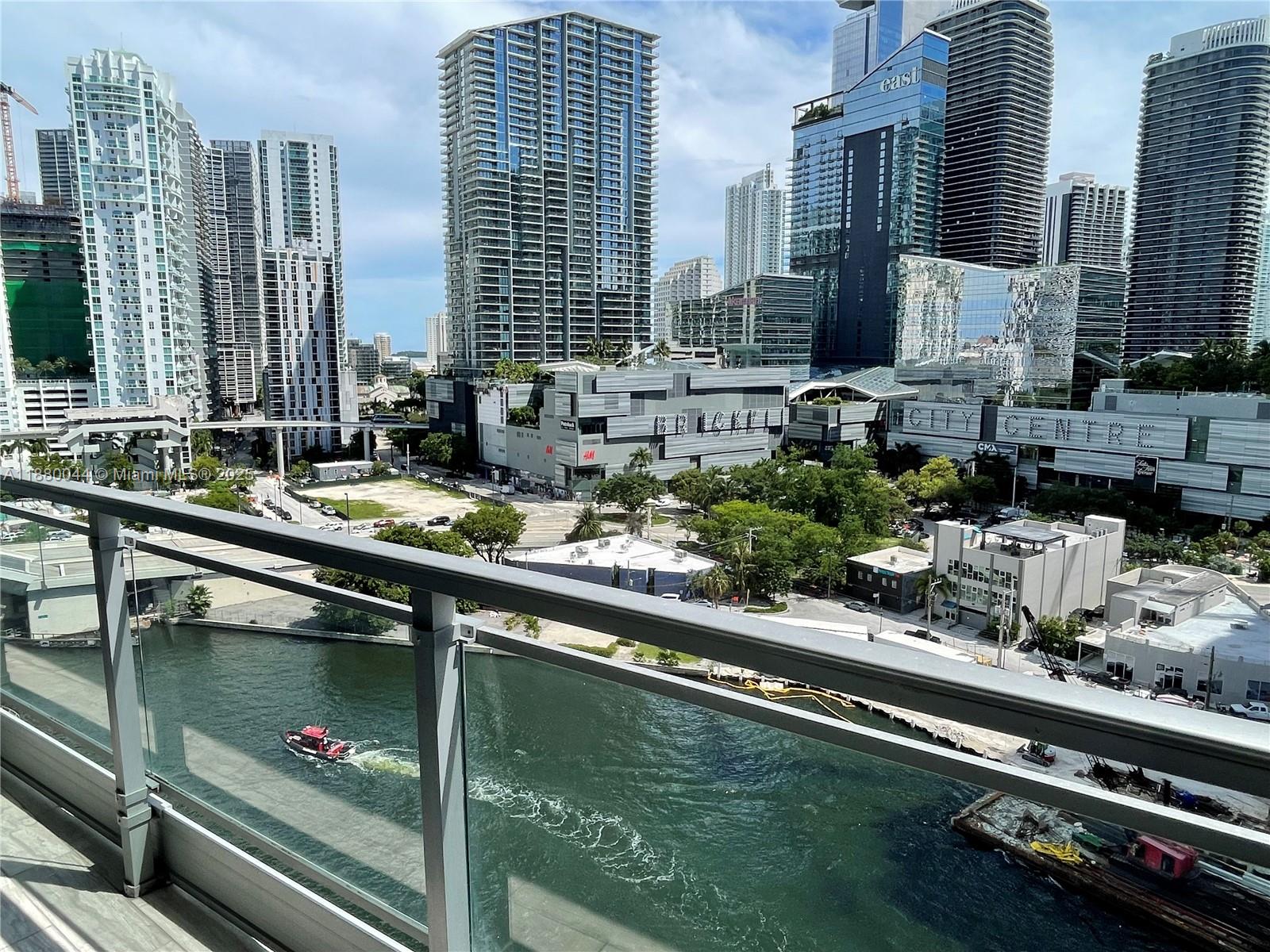 92 Southwest 3rd Street, Unit 1602 Miami, FL 33130 - Photo 12 of 48 a swimming pool with outdoor seating and yard