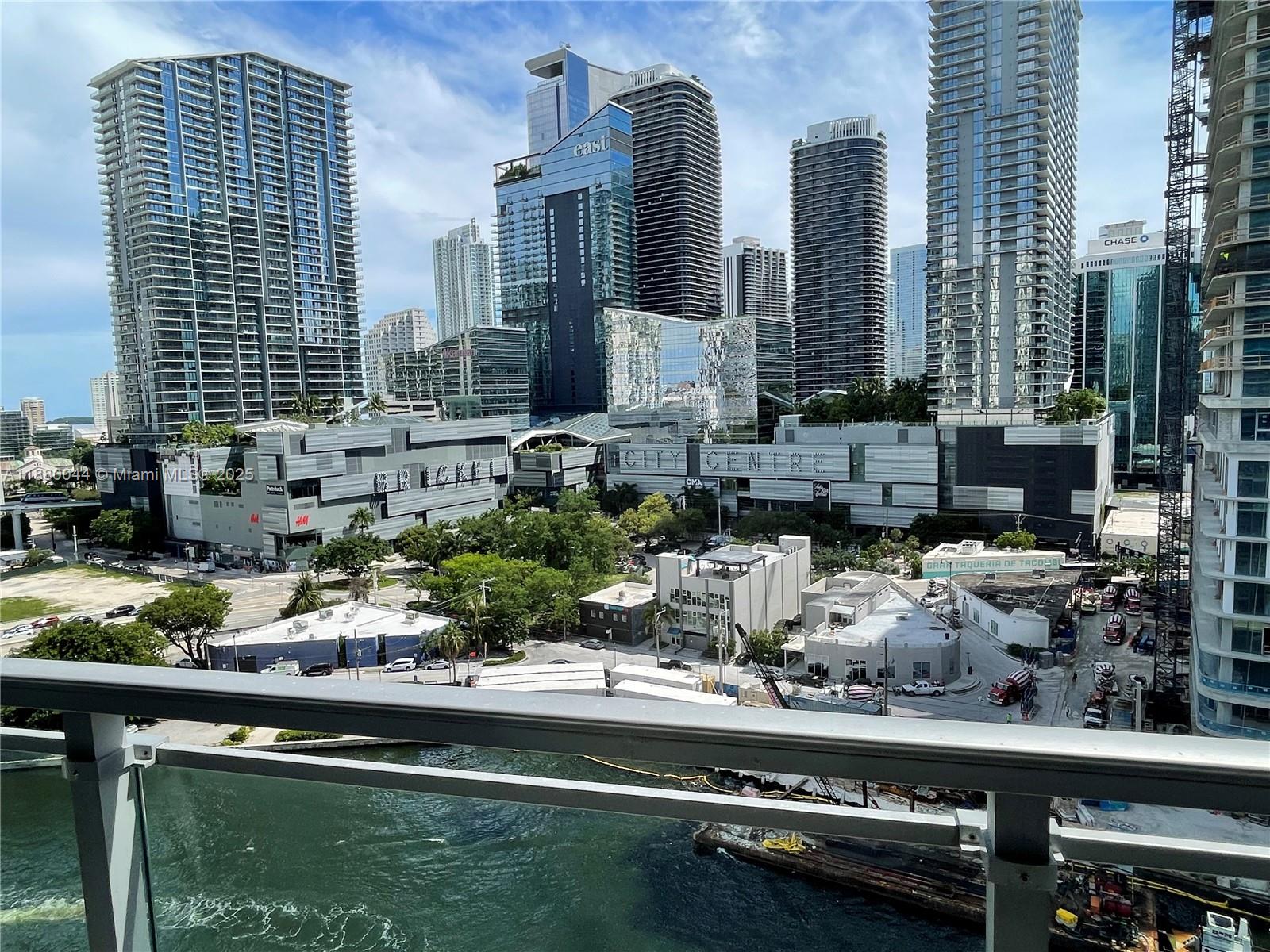 92 Southwest 3rd Street, Unit 1602 Miami, FL 33130 - Photo 13 of 48 a view of open kitchen with granite countertop and stainless steel appliances