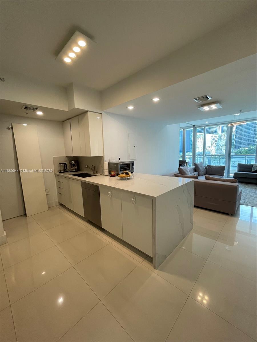 92 Southwest 3rd Street, Unit 1602 Miami, FL 33130 - Photo 14 of 48 a large kitchen with stainless steel appliances lots of counter top space