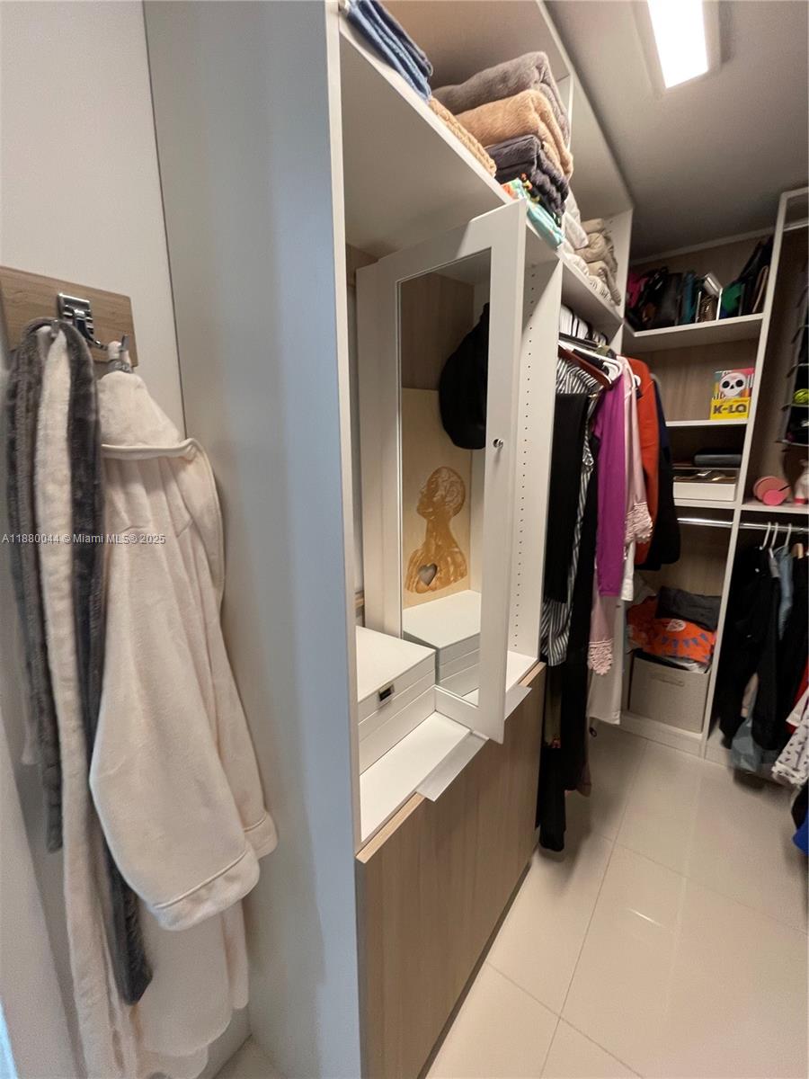 92 Southwest 3rd Street, Unit 1602 Miami, FL 33130 - Photo 22 of 48 a view of walk in closet with clothes and shoes