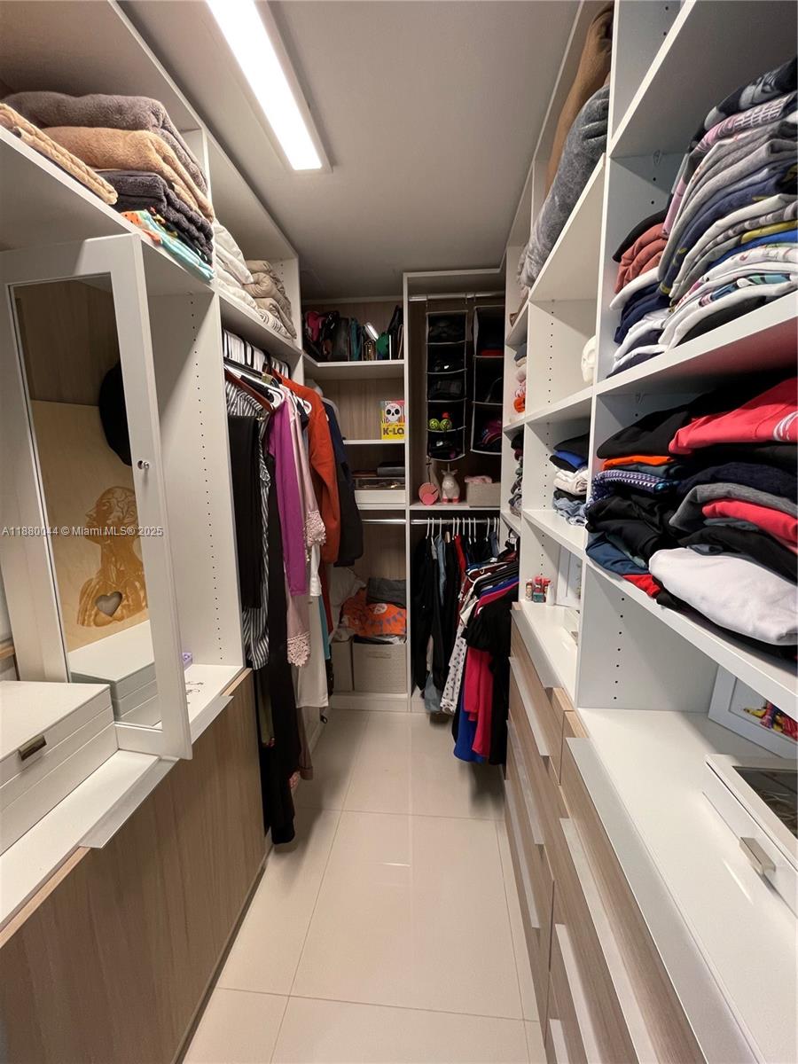 92 Southwest 3rd Street, Unit 1602 Miami, FL 33130 - Photo 23 of 48 a view of walk in closet with clothes and shoes