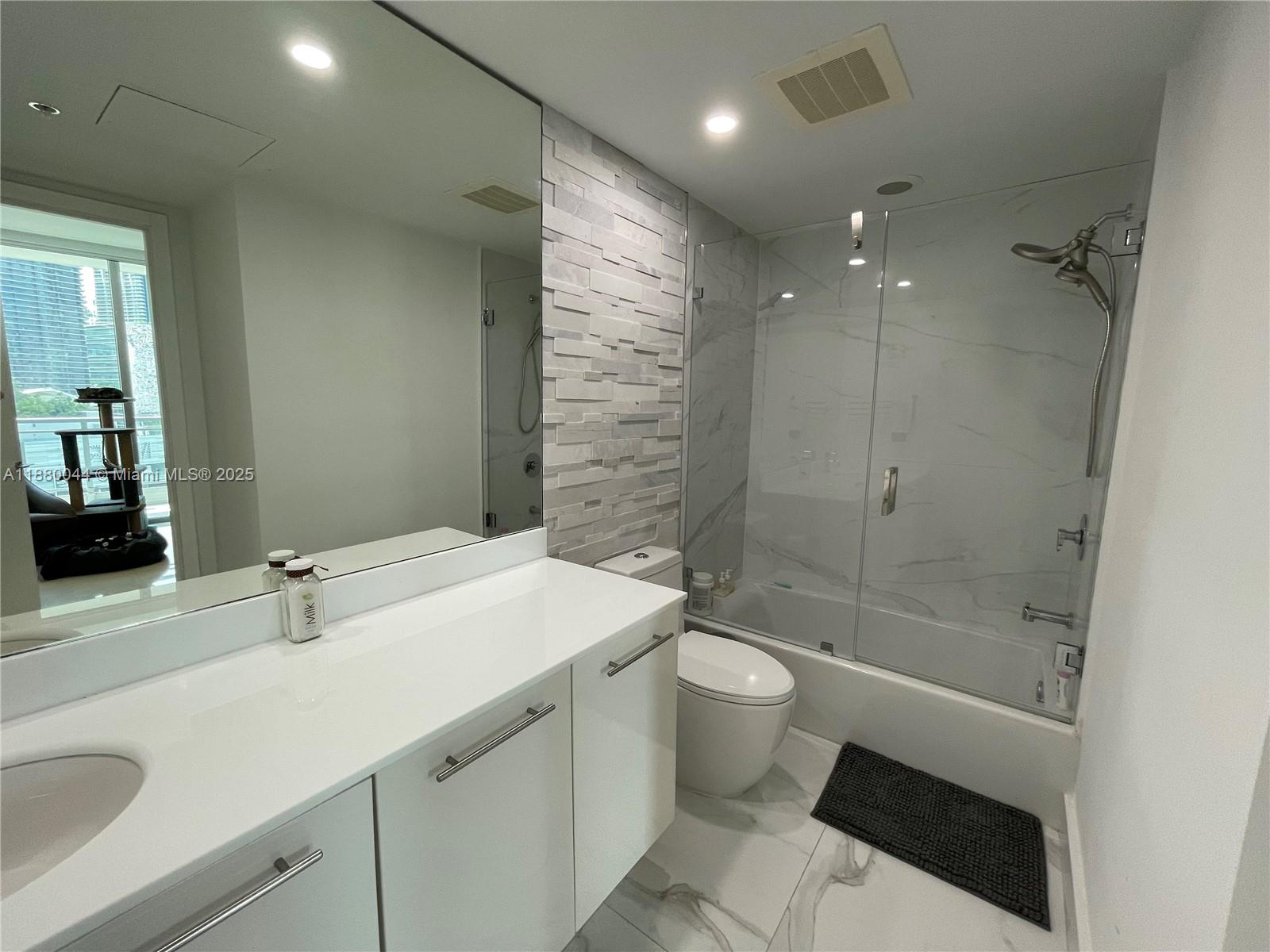 92 Southwest 3rd Street, Unit 1602 Miami, FL 33130 - Photo 26 of 48 a bathroom with a sink a toilet and shower