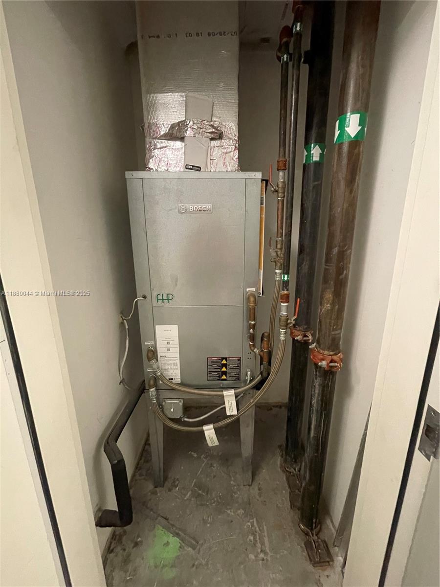92 Southwest 3rd Street, Unit 1602 Miami, FL 33130 - Photo 28 of 48 a room with water heater and a wooden door