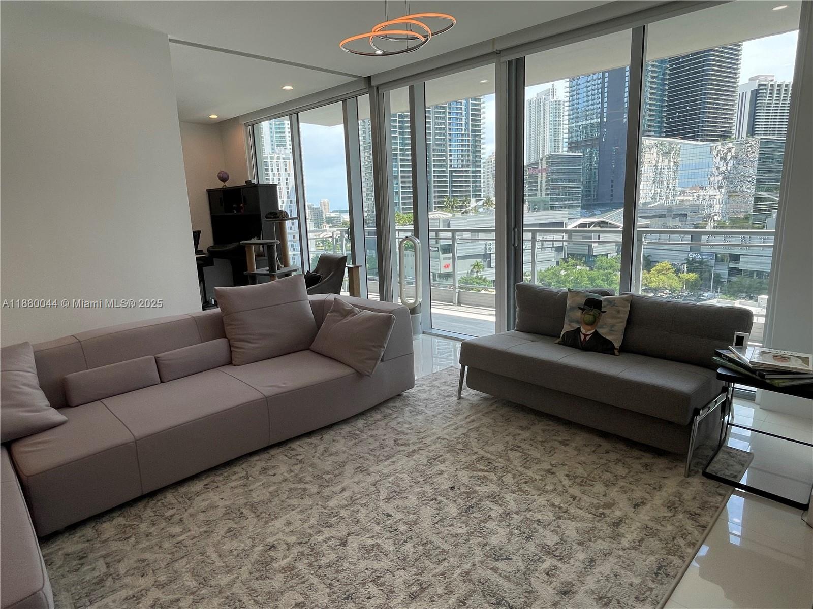 92 Southwest 3rd Street, Unit 1602 Miami, FL 33130 - Photo 31 of 48 a living room with furniture and a flat screen tv