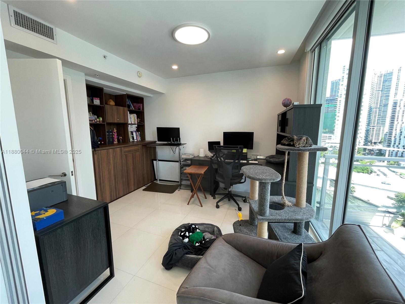 92 Southwest 3rd Street, Unit 1602 Miami, FL 33130 - Photo 32 of 48 a living room with furniture and a flat screen tv