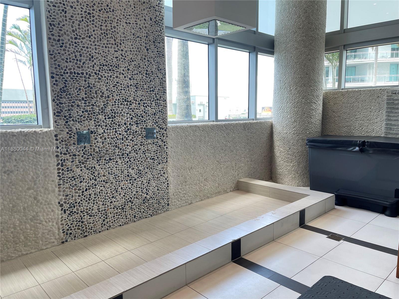 92 Southwest 3rd Street, Unit 1602 Miami, FL 33130 - Photo 40 of 48 a bathroom with a bathtub and window