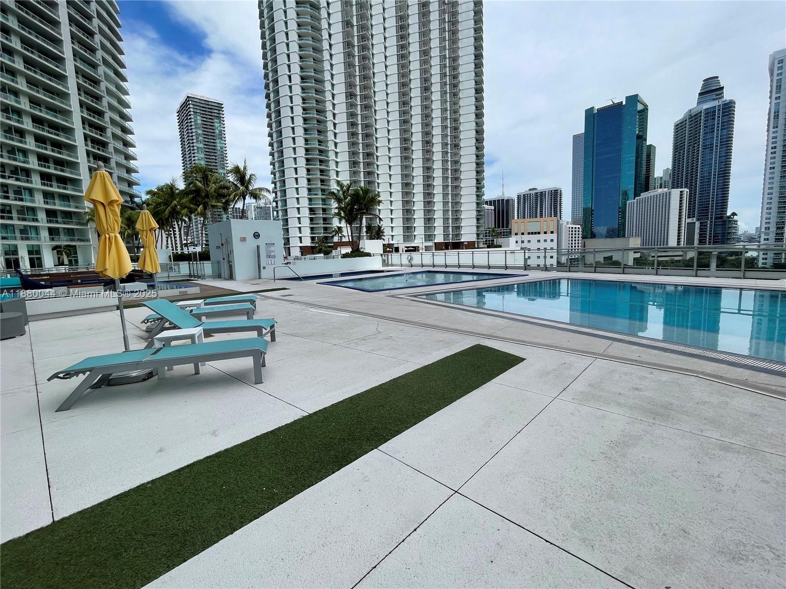 92 Southwest 3rd Street, Unit 1602 Miami, FL 33130 - Photo 43 of 48 a view of a swimming pool with chairs