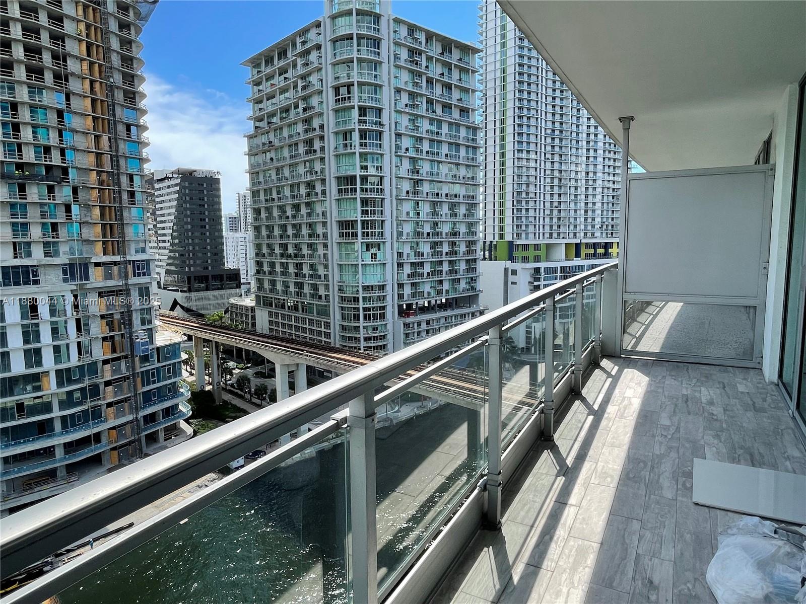 92 Southwest 3rd Street, Unit 1602 Miami, FL 33130 - Photo 10 of 48 a view of balcony with a couple of cars parked in front of a house