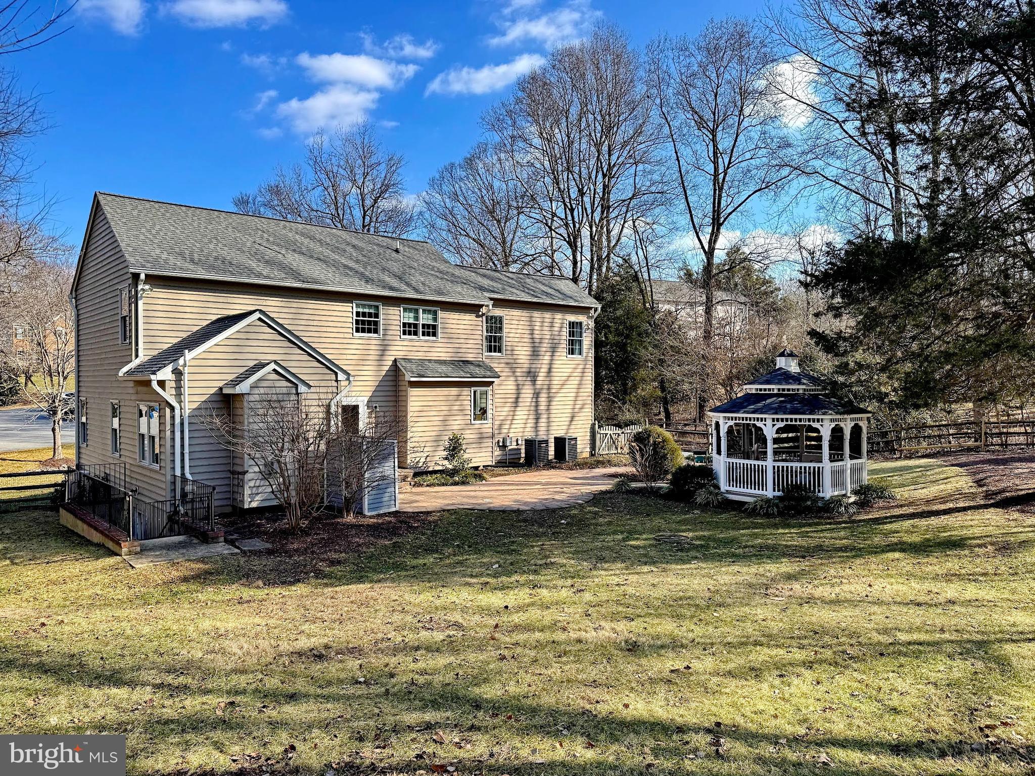 4060 Loving Drive Dunkirk, MD 20754 - Photo 19 of 83 a front view of a house with a yard table and chairs