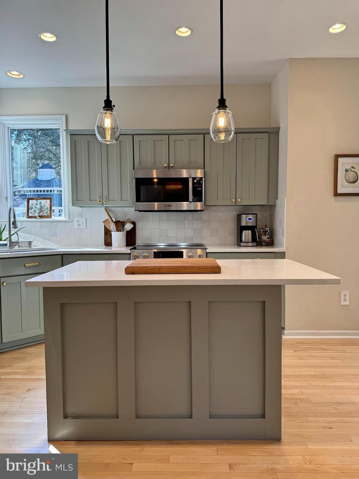 4060 Loving Drive Dunkirk, MD 20754 - Photo 42 of 83 a kitchen with kitchen island granite countertop a sink a counter space appliances and cabinets