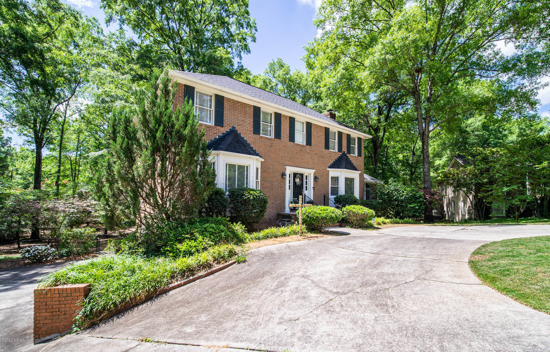 245 Beacon Hill Road Macon, GA 31210 - Photo 2 of 39 a front view of a house with a yard and potted plants