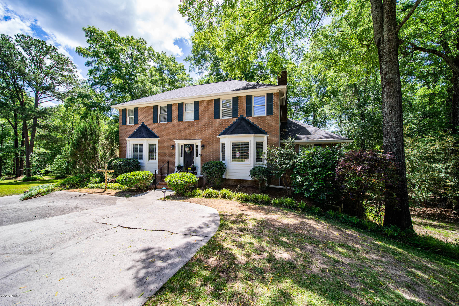 245 Beacon Hill Road Macon, GA 31210 - Photo 3 of 39 a front view of a house with a yard and potted plants
