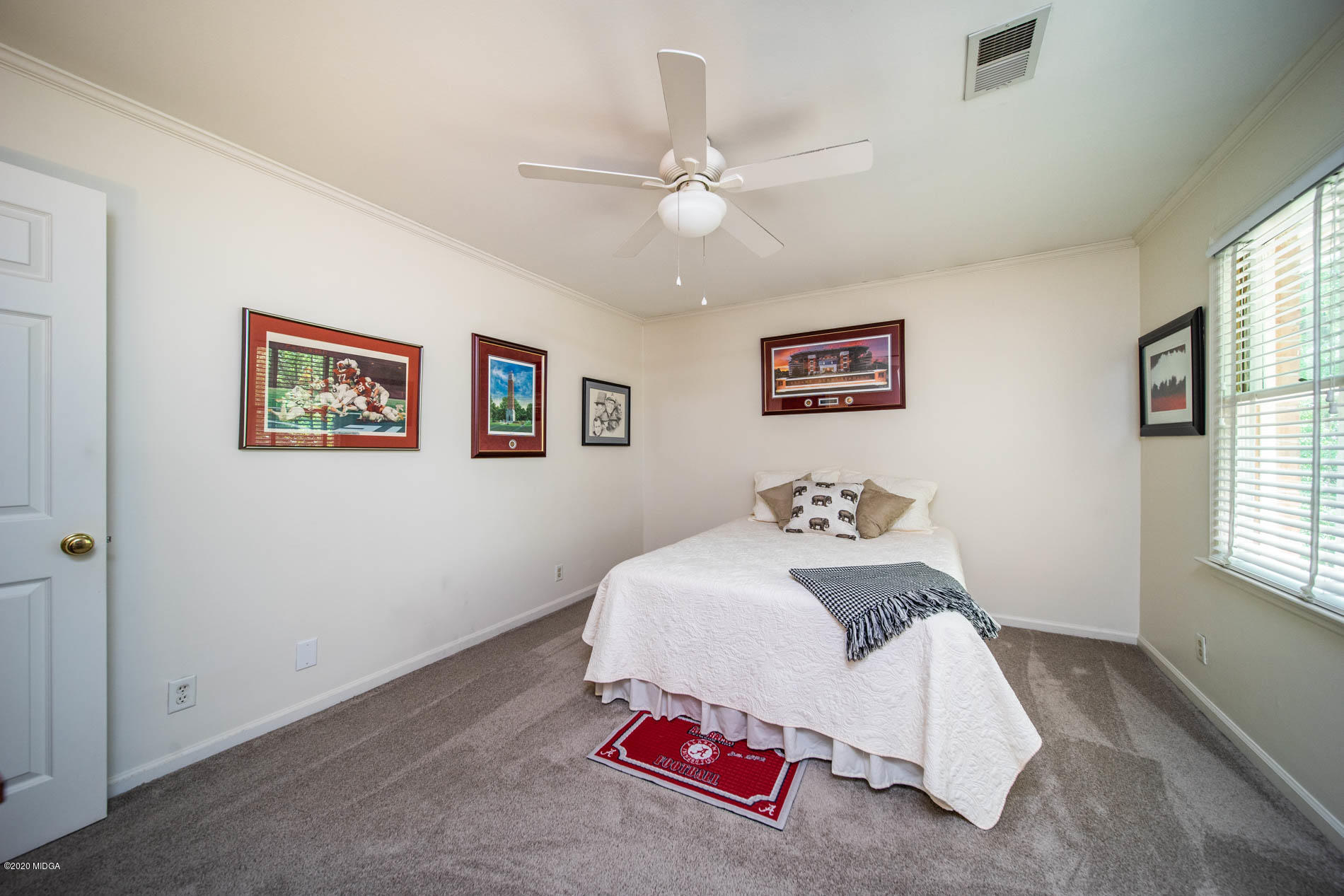 245 Beacon Hill Road Macon, GA 31210 - Photo 26 of 39 a bedroom with a bed and a chandelier