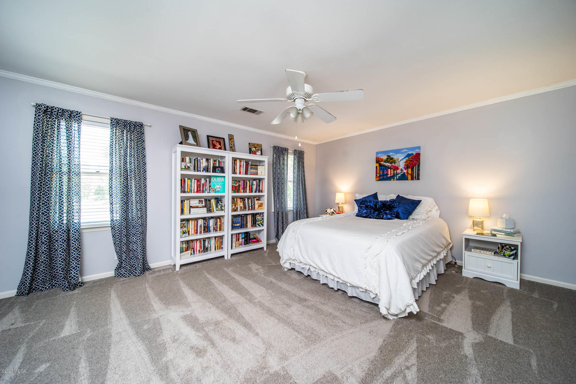 245 Beacon Hill Road Macon, GA 31210 - Photo 28 of 39 a bedroom with a large bed and a chandelier