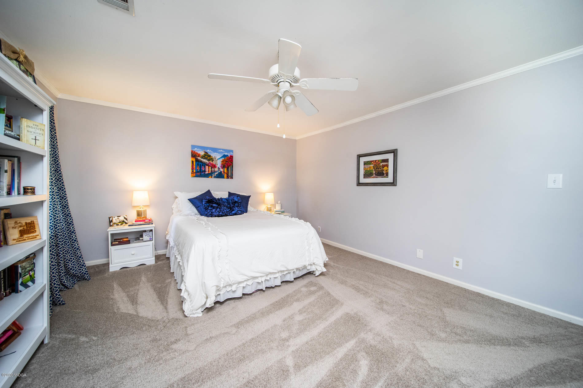 245 Beacon Hill Road Macon, GA 31210 - Photo 29 of 39 a spacious bedroom with a bed and a chandelier