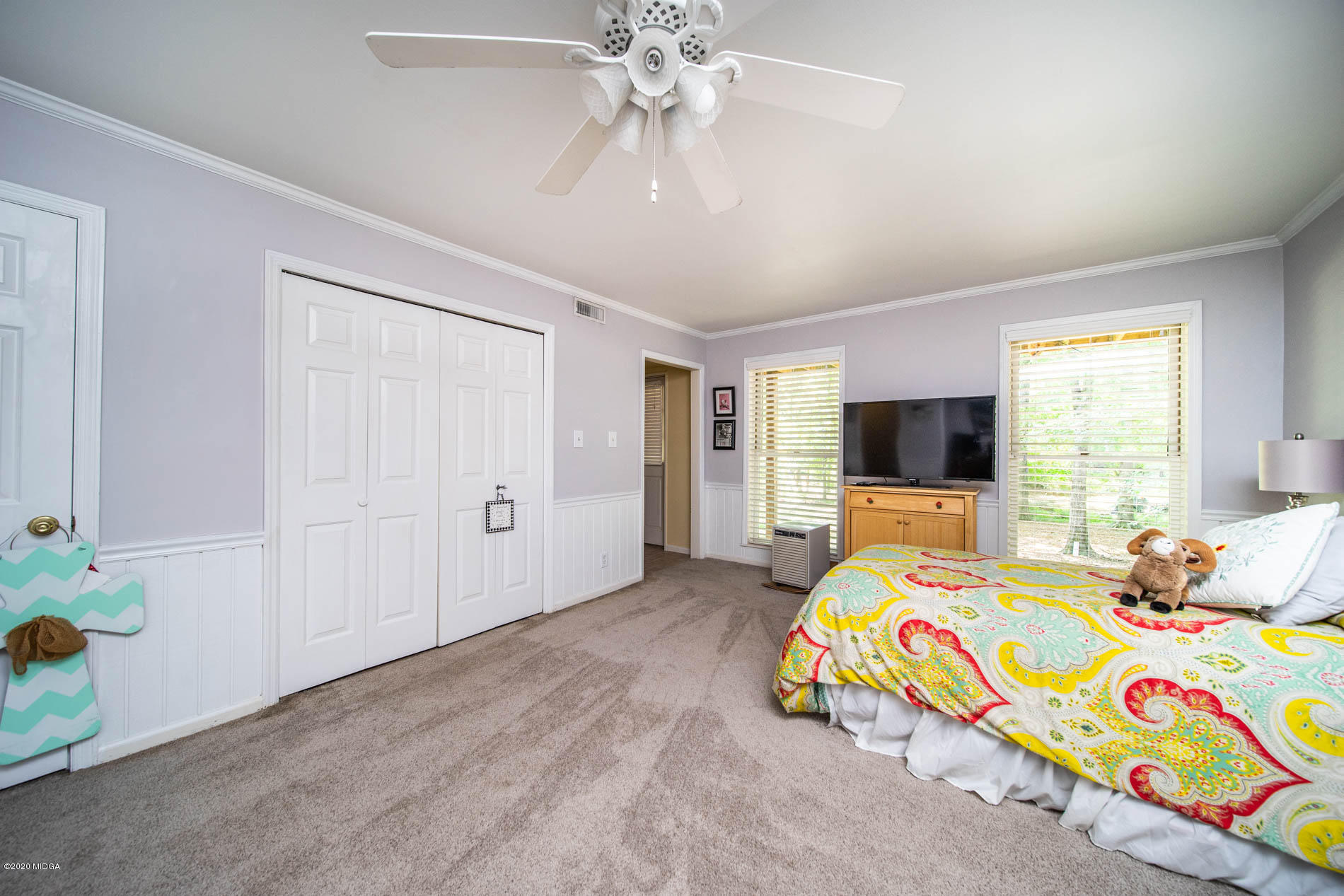 245 Beacon Hill Road Macon, GA 31210 - Photo 31 of 39 a bedroom with a bed and a flat screen tv