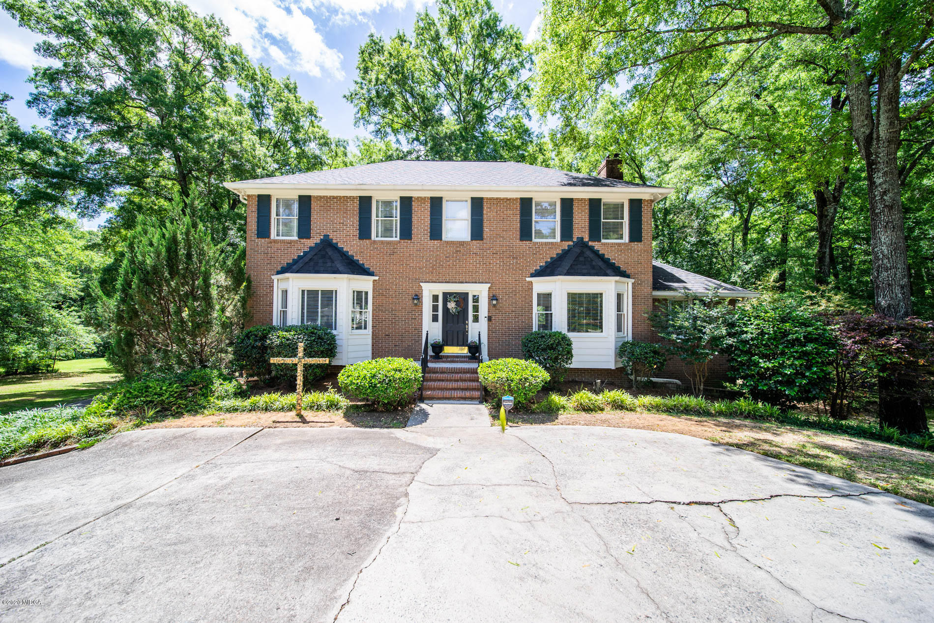 245 Beacon Hill Road Macon, GA 31210 - Photo 39 of 39 a front view of a house with a yard and potted plants