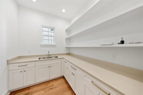 a view of a kitchen with white cabinets