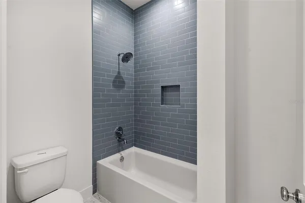 a bathroom with a toilet and bathtub