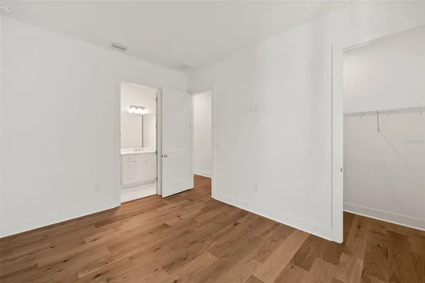 a view of empty room with wooden floor