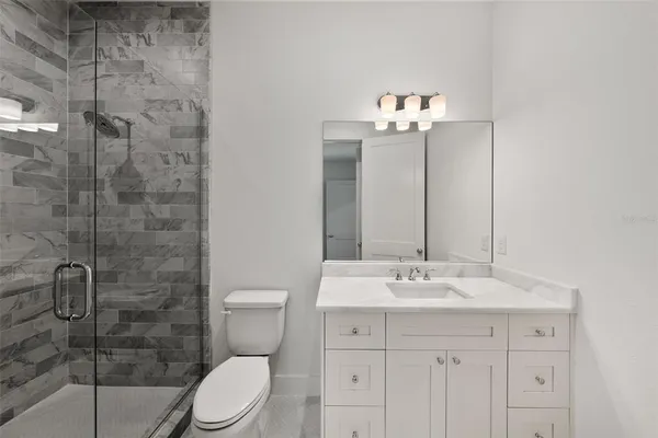 a bathroom with a toilet sink and shower