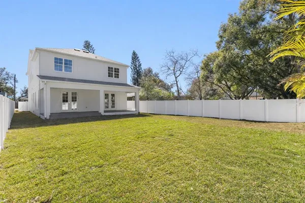 a house view with swimming pool in front of it