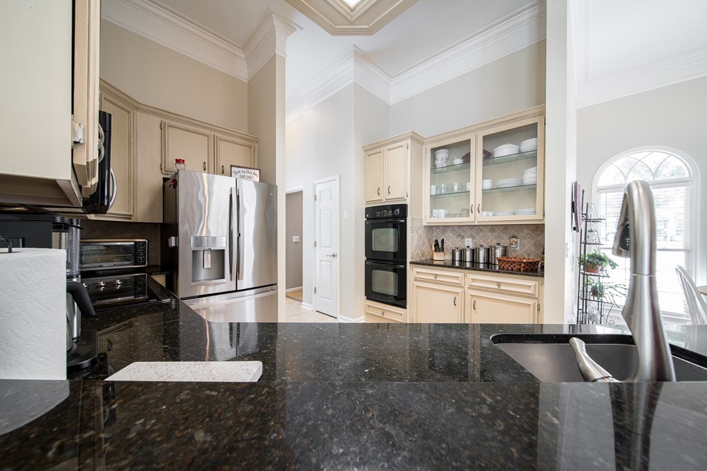 64 North Buckeye Loop Midland, GA 31820 - Photo 19 of 51 a kitchen with stainless steel appliances kitchen island granite countertop a refrigerator a stove and white cabinets with wooden floor