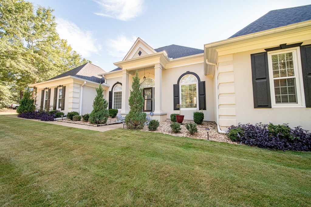 64 North Buckeye Loop Midland, GA 31820 - Photo 3 of 51 a front view of a house with garden