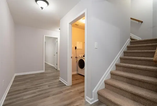 a view of an entryway with wooden floor