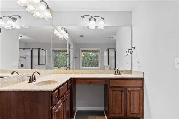 a bathroom with a sink double vanity and a mirror