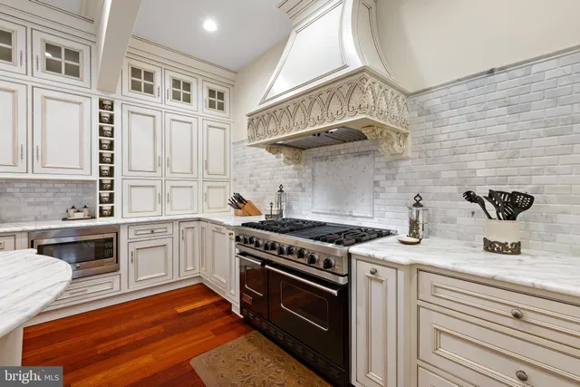 a living room with furniture a fireplace and a chandelier