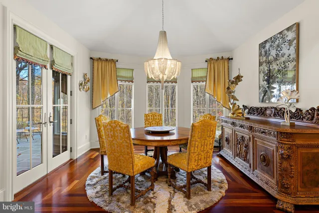 a living room with furniture large window and wooden floor