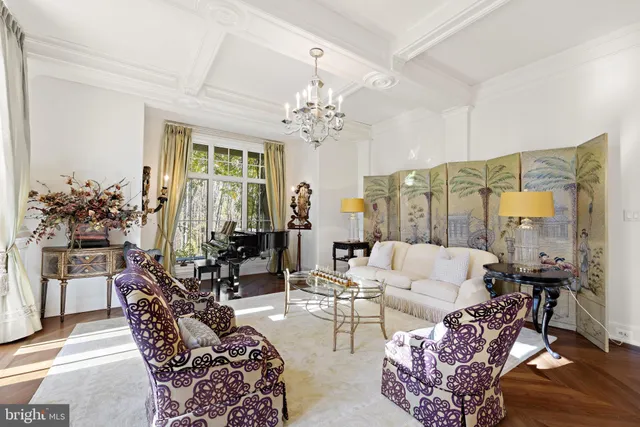 a living room with furniture and chandelier