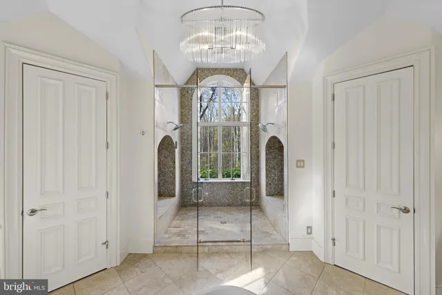 a patio with table and chairs and potted plants