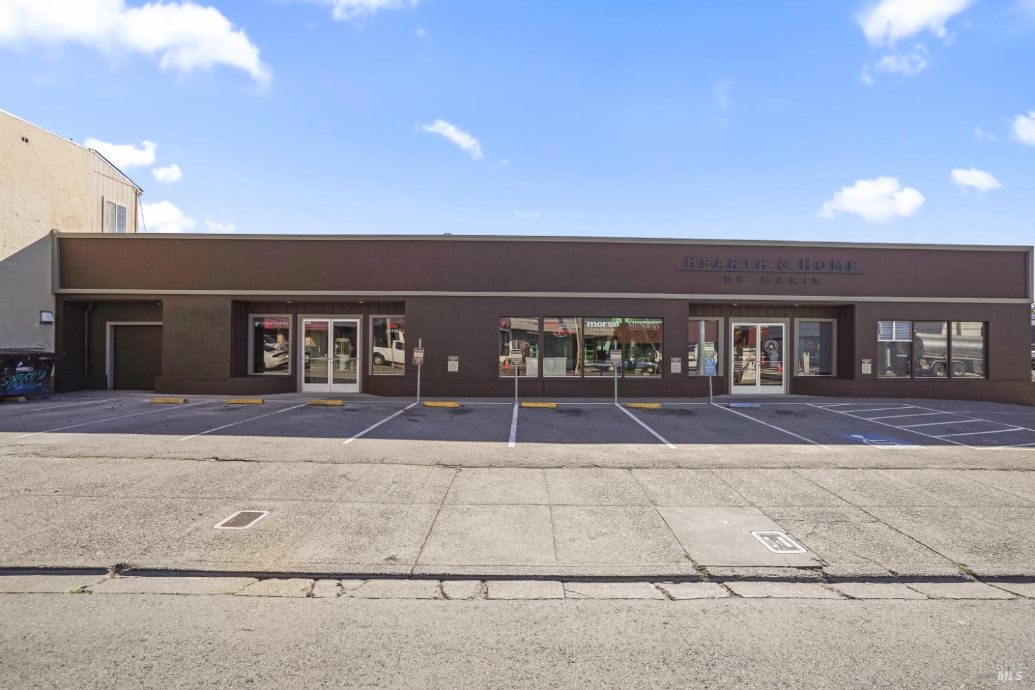 front view of a brick house with a yard