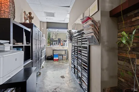 a view of an empty room with a fireplace and a window