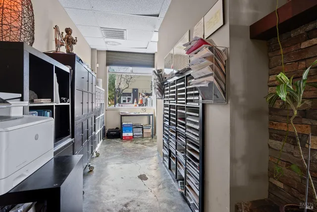 a view of an empty room with a fireplace and a window